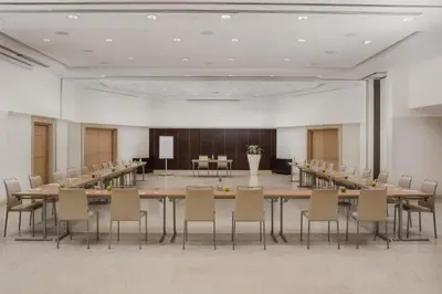 a conference room with a long table and chairs at NH Collection Roma Giustiniano in Rome