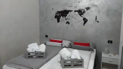 a bedroom with a bed and a world map on the wall at B&B J&B in Rome