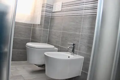 a bathroom with a toilet and a sink at B&B J&B in Rome