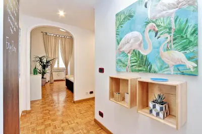 a hallway with a painting of flamingos on the wall at Parrotshouse in Rome