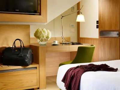 a hotel room with a bed and a desk at Babuino 181 - Small Luxury Hotels of the World in Rome