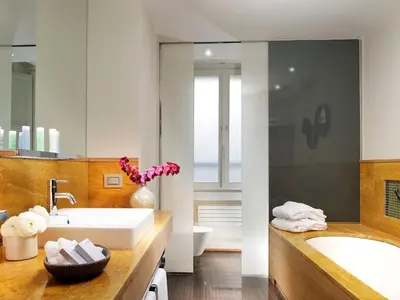 a bathroom with a tub and a sink and a toilet at Babuino 181 - Small Luxury Hotels of the World in Rome