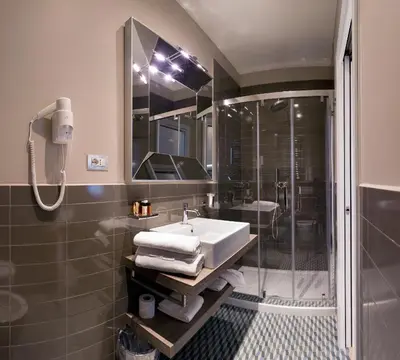 a bathroom with a sink and a shower at Deseo Home Guest House in Rome