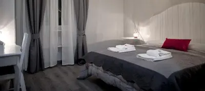 a bedroom with a bed with towels on it at TinkerBell GuestHouse in Rome