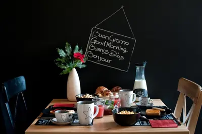 a table with food and a chalkboard sign on it at TinkerBell GuestHouse in Rome