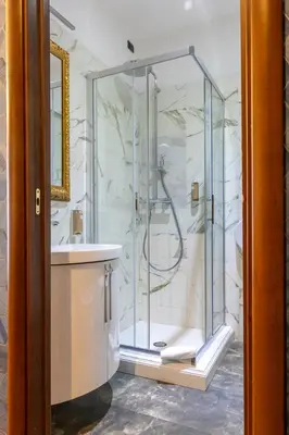 a glass shower in a bathroom with a sink at Vatican Plaza in Rome