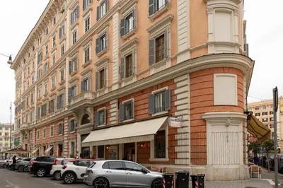a large brick building with cars parked in front of it at Vatican Plaza in Rome
