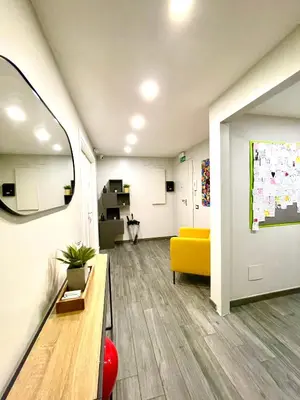 an office with a yellow couch and a waiting room at Your House By Ale in Rome