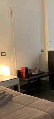 a room with a bed and a desk with a table at Your House By Ale in Rome
