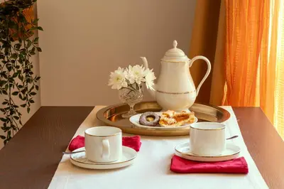 a table with two cups and a tea pot on it at B&B A Casa di Tiziana - Roma in Rome