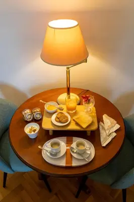 a table with a tray of food and a lamp at B&B A Casa di Tiziana - Roma in Rome