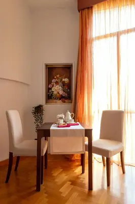a dining room with a table and two chairs at B&B A Casa di Tiziana - Roma in Rome