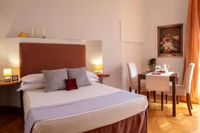 a hotel room with a bed and a table at B&B A Casa di Tiziana - Roma in Rome