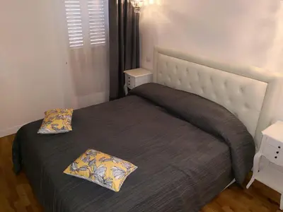 a bedroom with a bed with a gray blanket and pillows at Urbana 33 in Rome