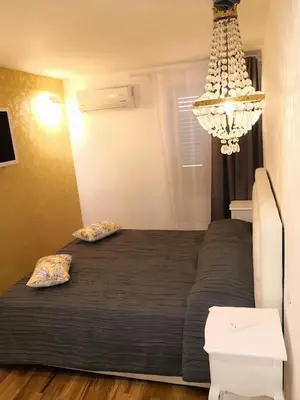 a bedroom with a bed and a chandelier at Urbana 33 in Rome