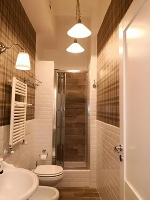 a bathroom with a shower and a toilet and a sink at Urbana 33 in Rome