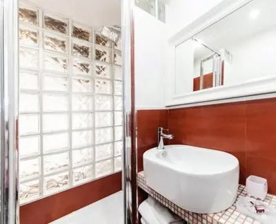 a bathroom with a white sink and a mirror at Urbana 33 in Rome