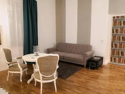 a living room with a couch and a table and chairs at Urbana 33 in Rome