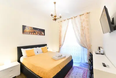 a bedroom with a large bed with white sheets and pillows at Vietitaly Filiberto in Rome