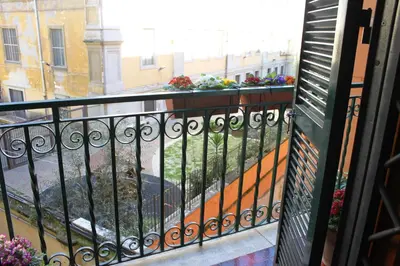 two potted flowers on a railing on a balcony at Vietitaly Filiberto in Rome