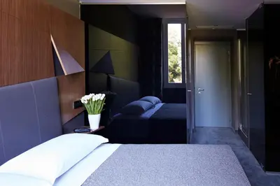 a bedroom with a large bed and a window at Hotel The Building in Rome