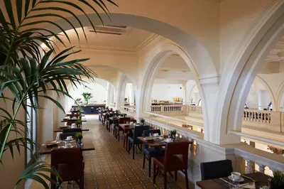 a restaurant with tables and chairs in a building at Hotel The Building in Rome