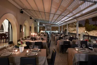 a restaurant with tables and chairs in a room at Hotel The Building in Rome