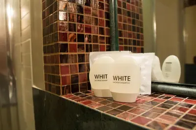 a counter with two bottles of white soap on it at Sweet Dream Trevi in Rome