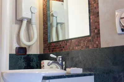 a bathroom with a sink and a mirror at Sweet Dream Trevi in Rome