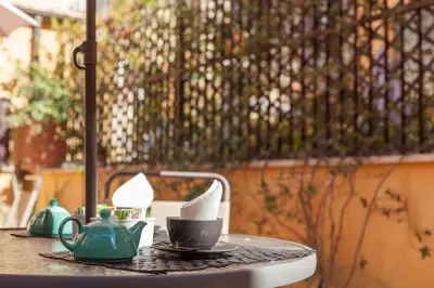 a table with cups and teapots on top of it at Sweet Dream Trevi in Rome