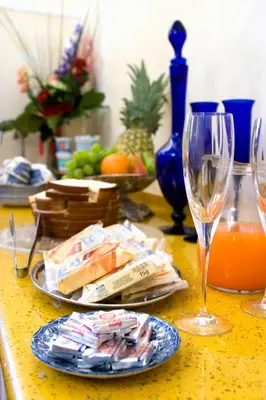 a table with a plate of food and a wine glass at Relais Conte Di Cavour De Luxe in Rome