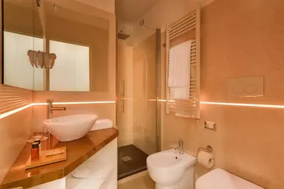 a bathroom with a sink and a toilet at Shali Luxury Suite Spagna in Rome