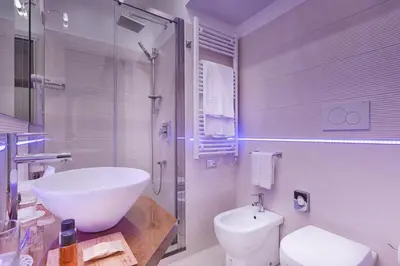 a white bathroom with a sink and a toilet at Shali Luxury Suite Spagna in Rome