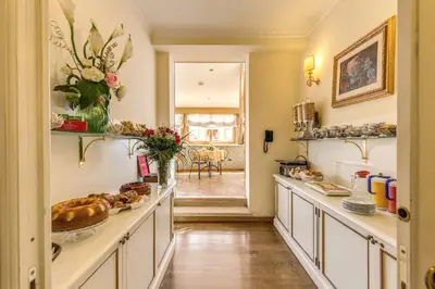 a kitchen with a long counter with food on it at Hotel La Lumiere Di Piazza Di Spagna in Rome