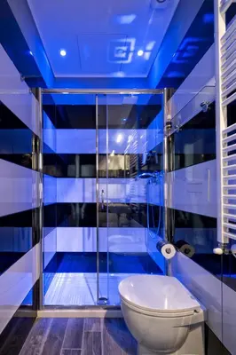 a bathroom with a toilet and a blue ceiling at Lea Luxury Rooms in Rome