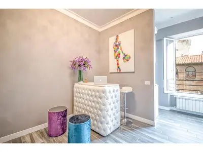 a room with a table with a laptop on it at Lea Luxury Rooms in Rome
