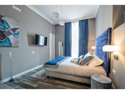 a bedroom with a bed and a large window at Lea Luxury Rooms in Rome