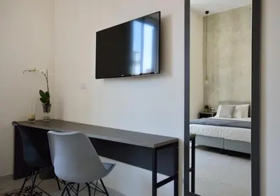 a room with a desk with a television on the wall at Room with a view 105 in Rome