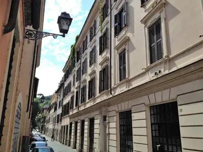 a street with buildings and cars parked on the street at Casa in Trastevere in Rome