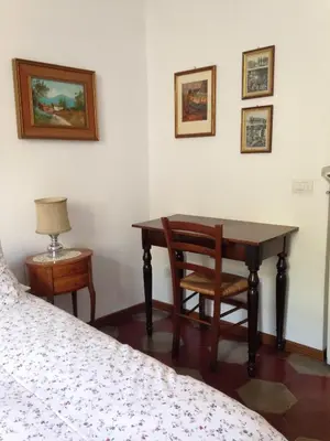 a bedroom with a desk and a table and chairs at Casa in Trastevere in Rome