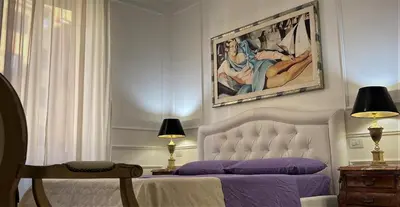 a bedroom with a bed and a painting on the wall at Bed And Breakfast King Plaza in Rome