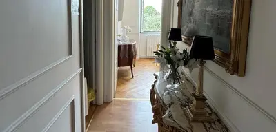 a hallway with a table with a vase of flowers on it at Bed And Breakfast King Plaza in Rome