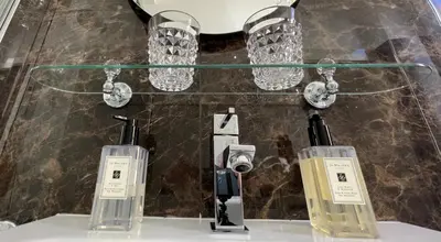 two perfume bottles on a counter with lights at Bed And Breakfast King Plaza in Rome