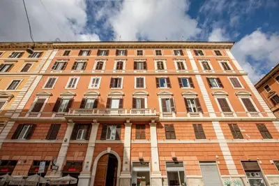 a large brick building with a balcony on the front at Domus Serafino in Rome