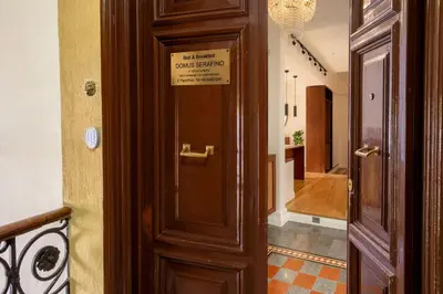 a wooden door in a hallway with a sign on it at Domus Serafino in Rome