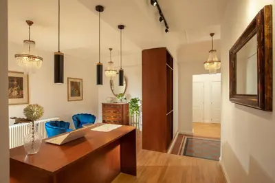 an office with a wooden desk and blue chairs at Domus Serafino in Rome