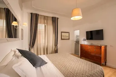 a bedroom with a bed and a flat screen tv at Domus Serafino in Rome