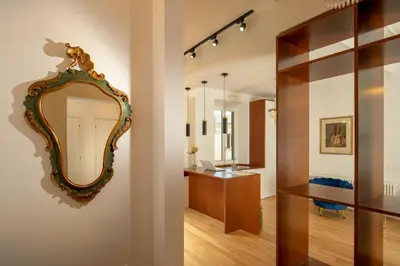 a bathroom with a mirror on the wall and a vanity at Domus Serafino in Rome
