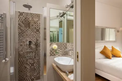 a bathroom with a sink next to a bed at Domus Serafino in Rome