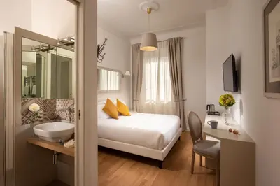 a hotel room with a bed and a sink at Domus Serafino in Rome